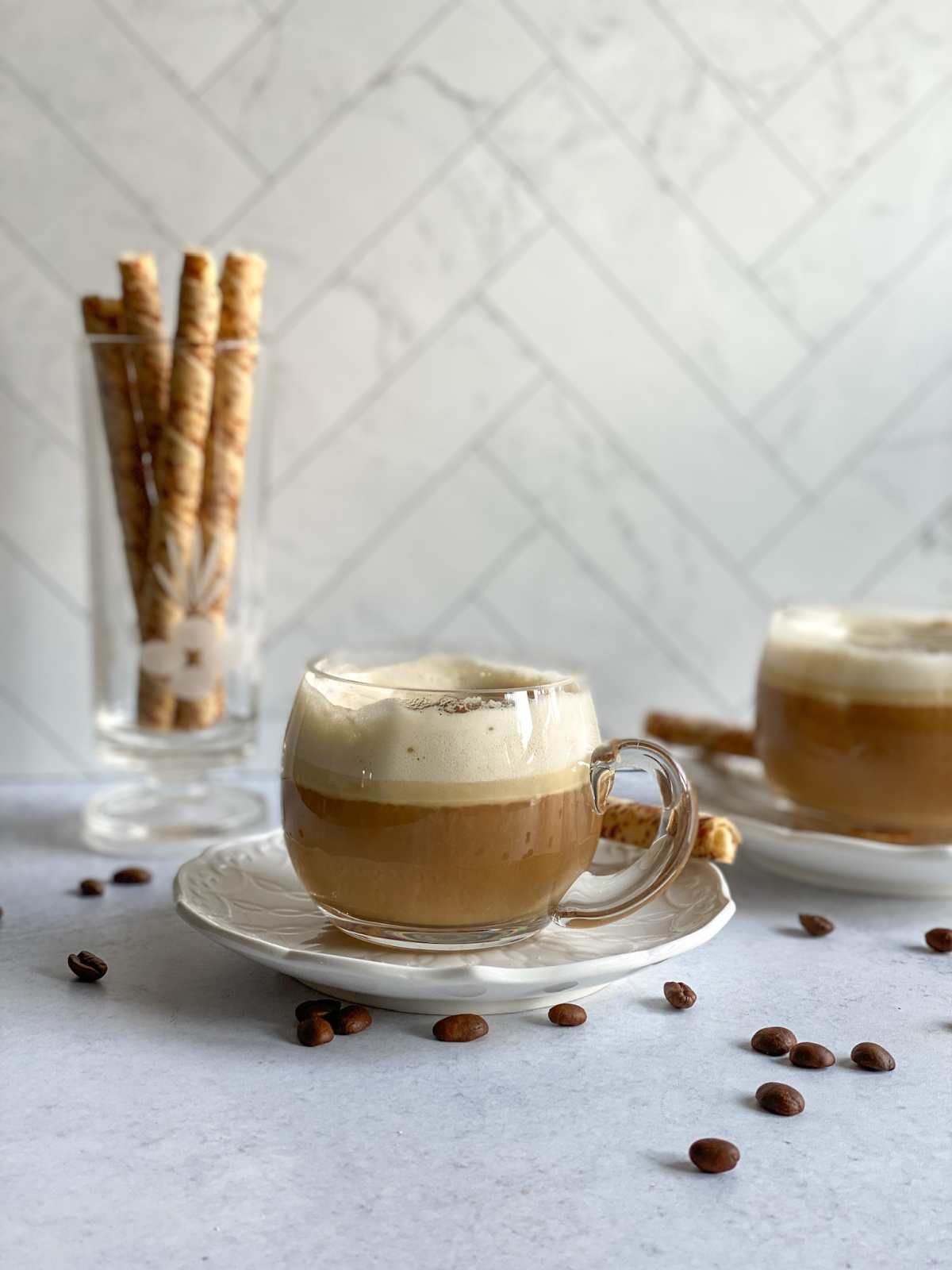 A cup of tequila coffee on top of a small plate