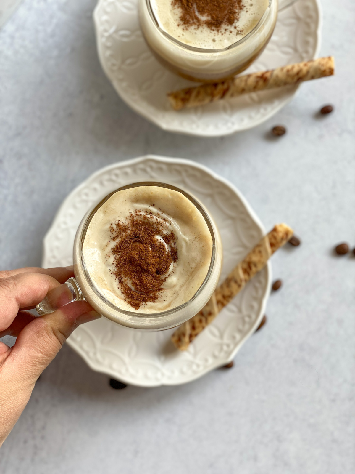 A hand holding a cup of Mexican-Style Irish Coffee