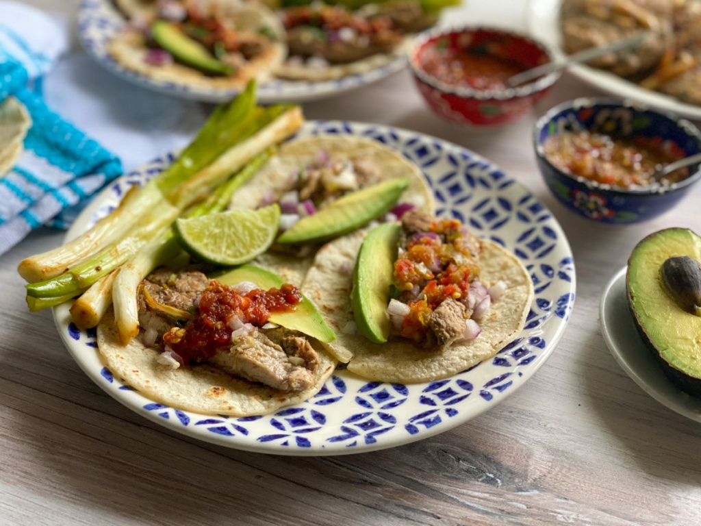 A plate with grilled veal tacos with onions