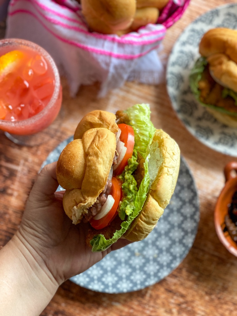 A hand holding a torta