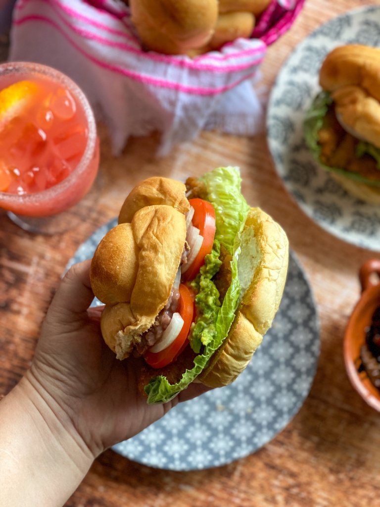 A hand holding a torta 