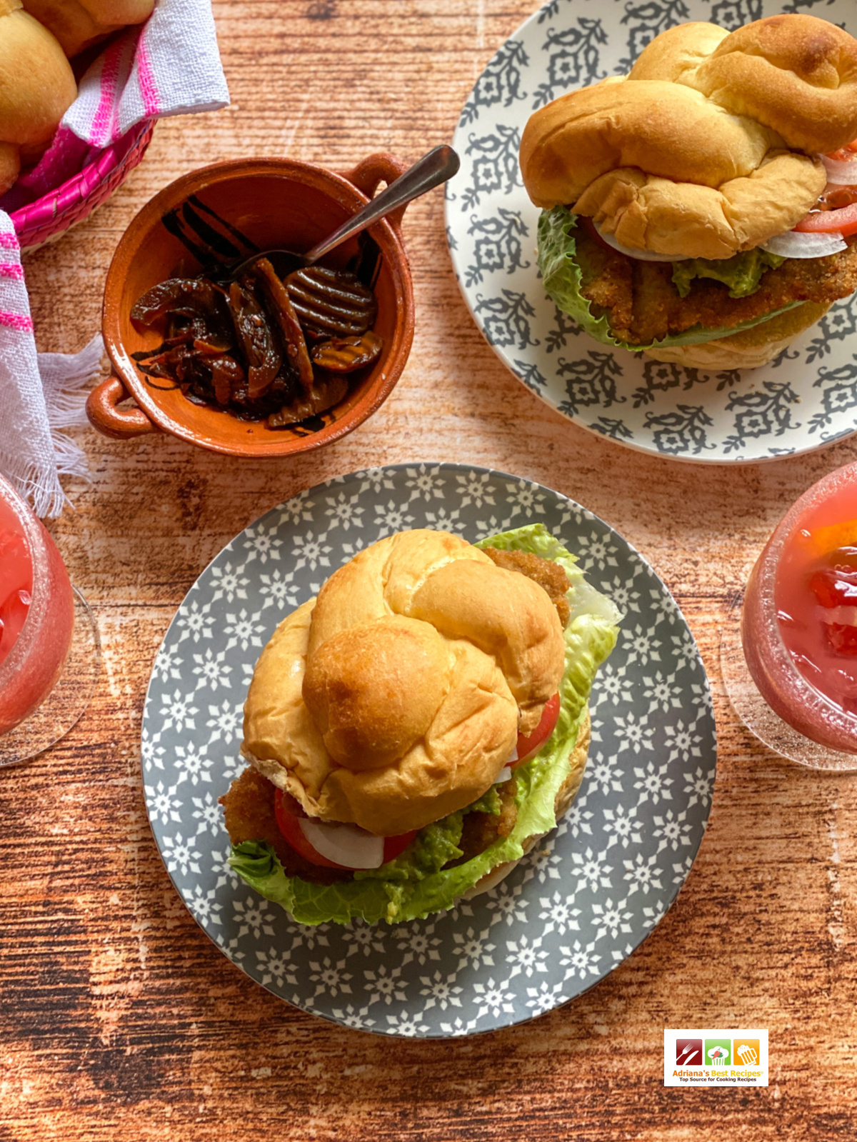 two warm sandwiches on top a wooden table