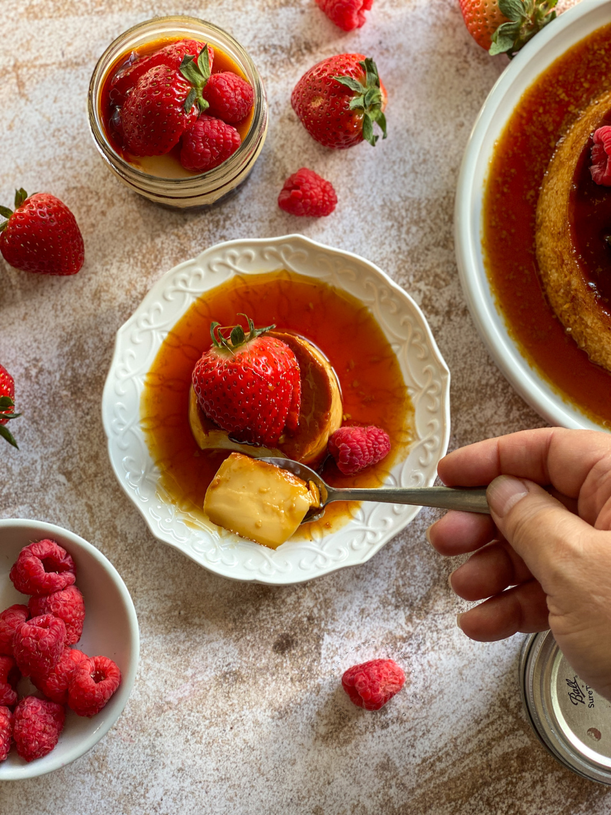 a hand with a spoonful of homemade custard