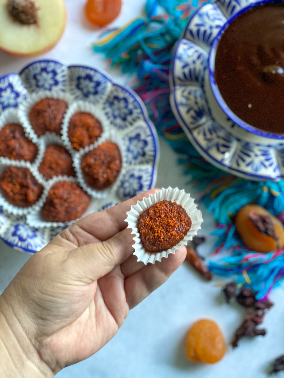 a hand holding a mexican homemade treat inspired in umeboshi using sour apricots