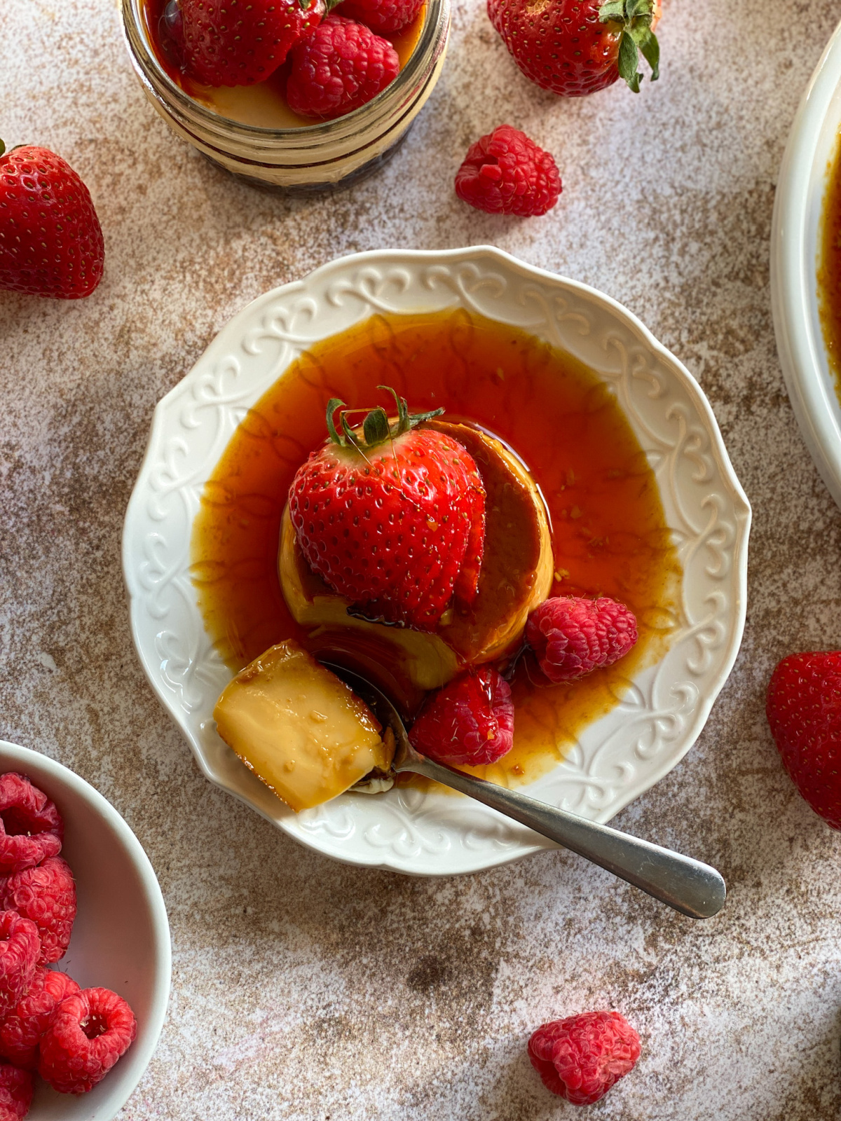 a spoon with a piece of custard made using precision cooking left on the plate