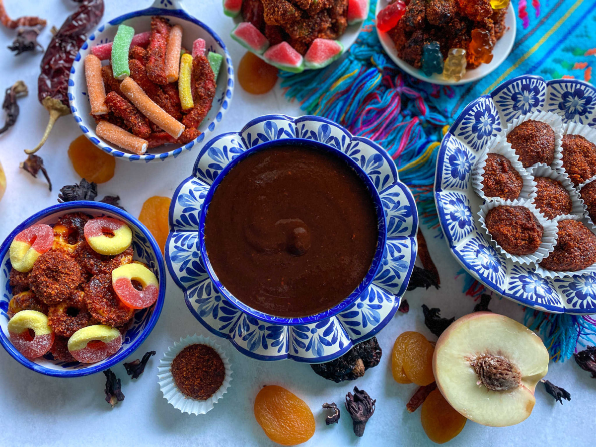 different bowls with homemade chamoy sauce and Mexican spicy treats