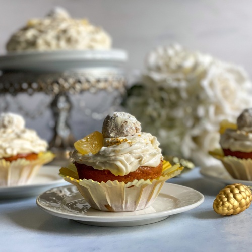 Yummy pineapple pecan cupcakes topped with a Mexican wedding cake cookie