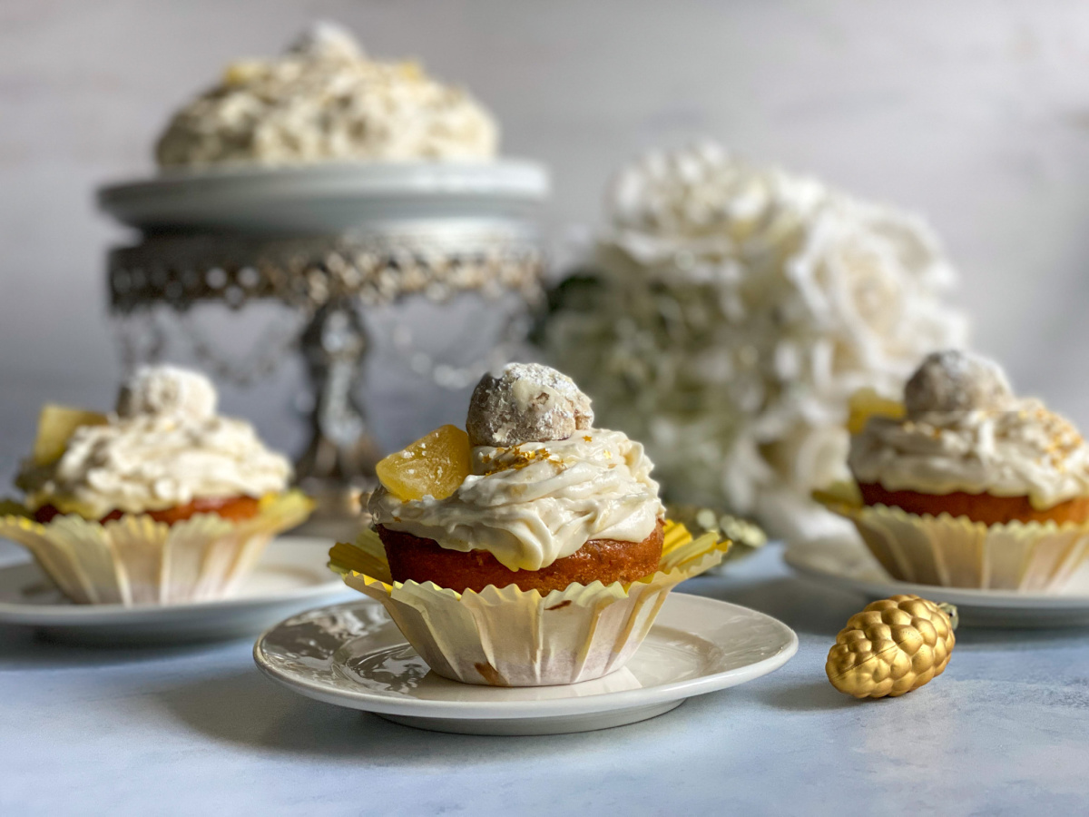 Yummy pineapple pecan cupcakes topped with a Mexican wedding cake cookie