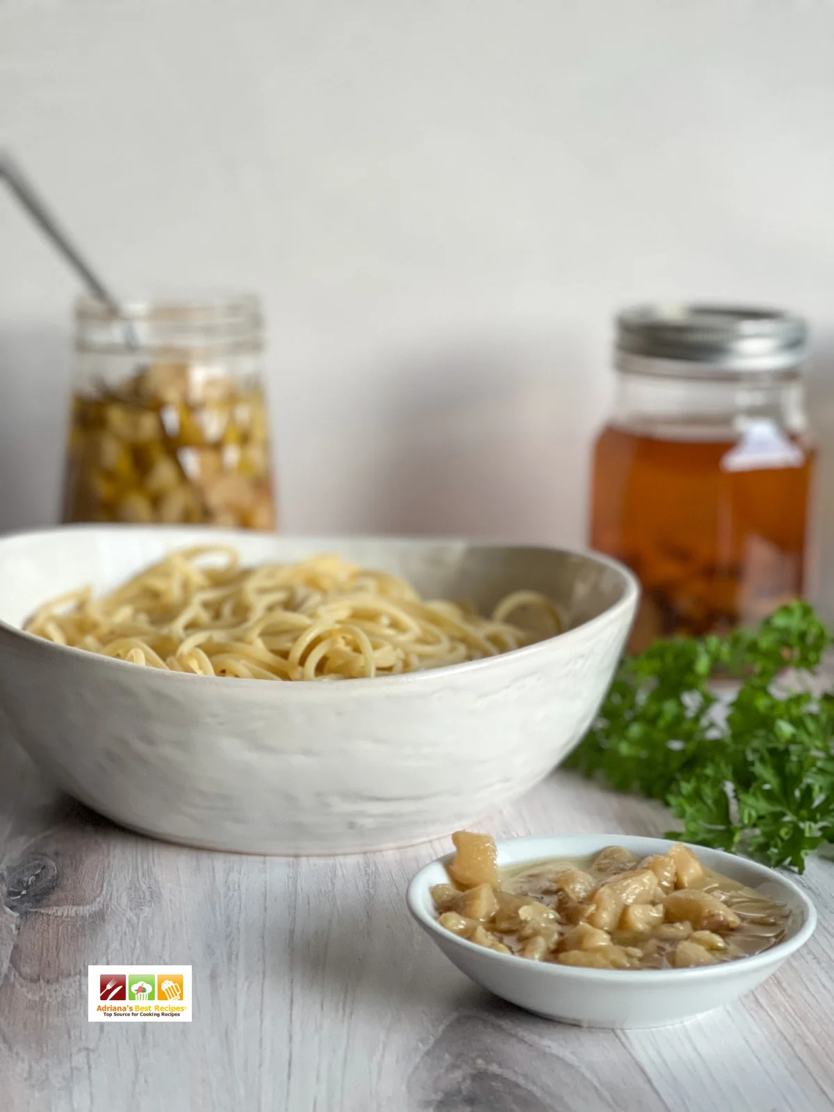 a bowl of pasta and chopped garlic with garlic oil