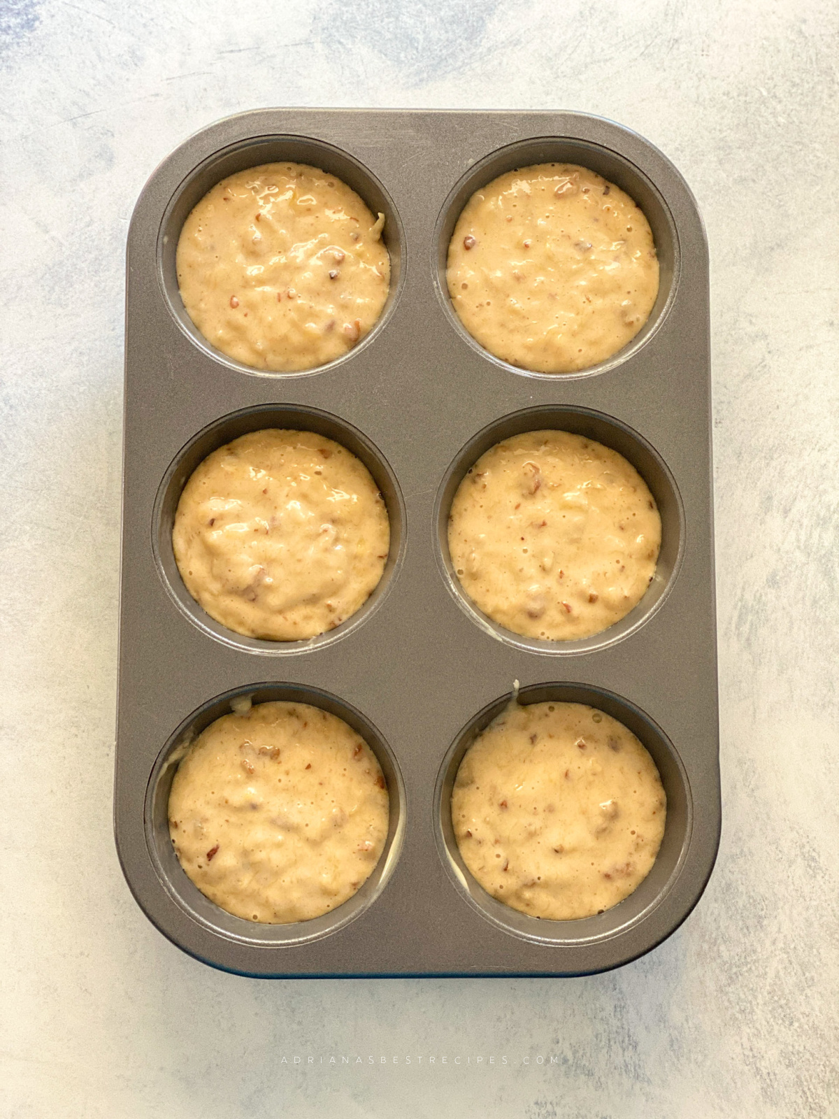 a small cake tin filled with batter ready to go inside the oven