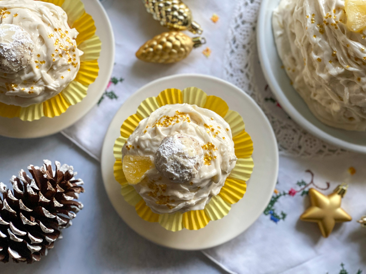 a frosted cupcake inside a yellow liner