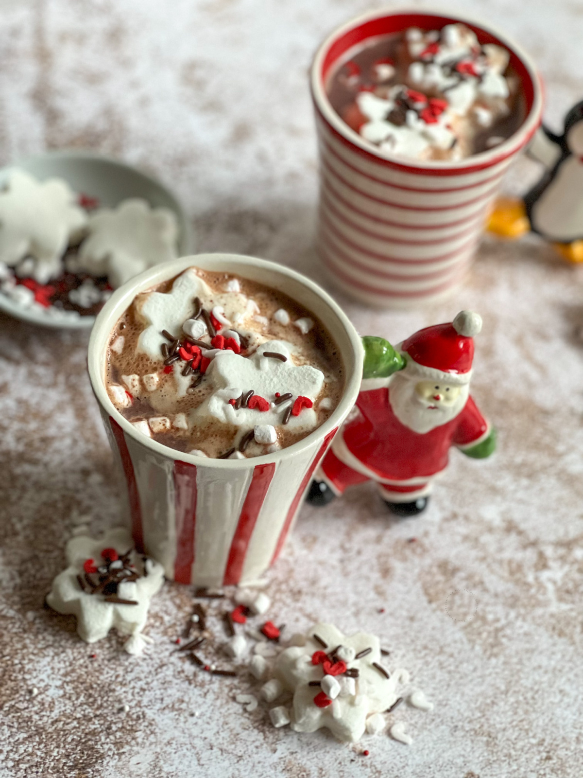 Two Christmas mugs with hot cocoa