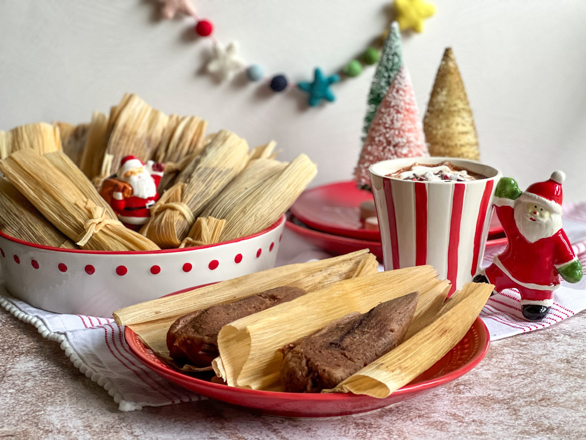 a plate served with chocolate tamales and hot cocoa