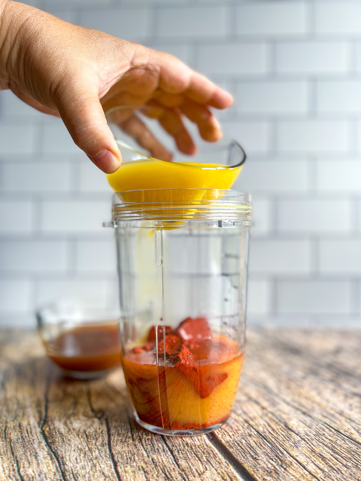 Pouring orange juice into the blender