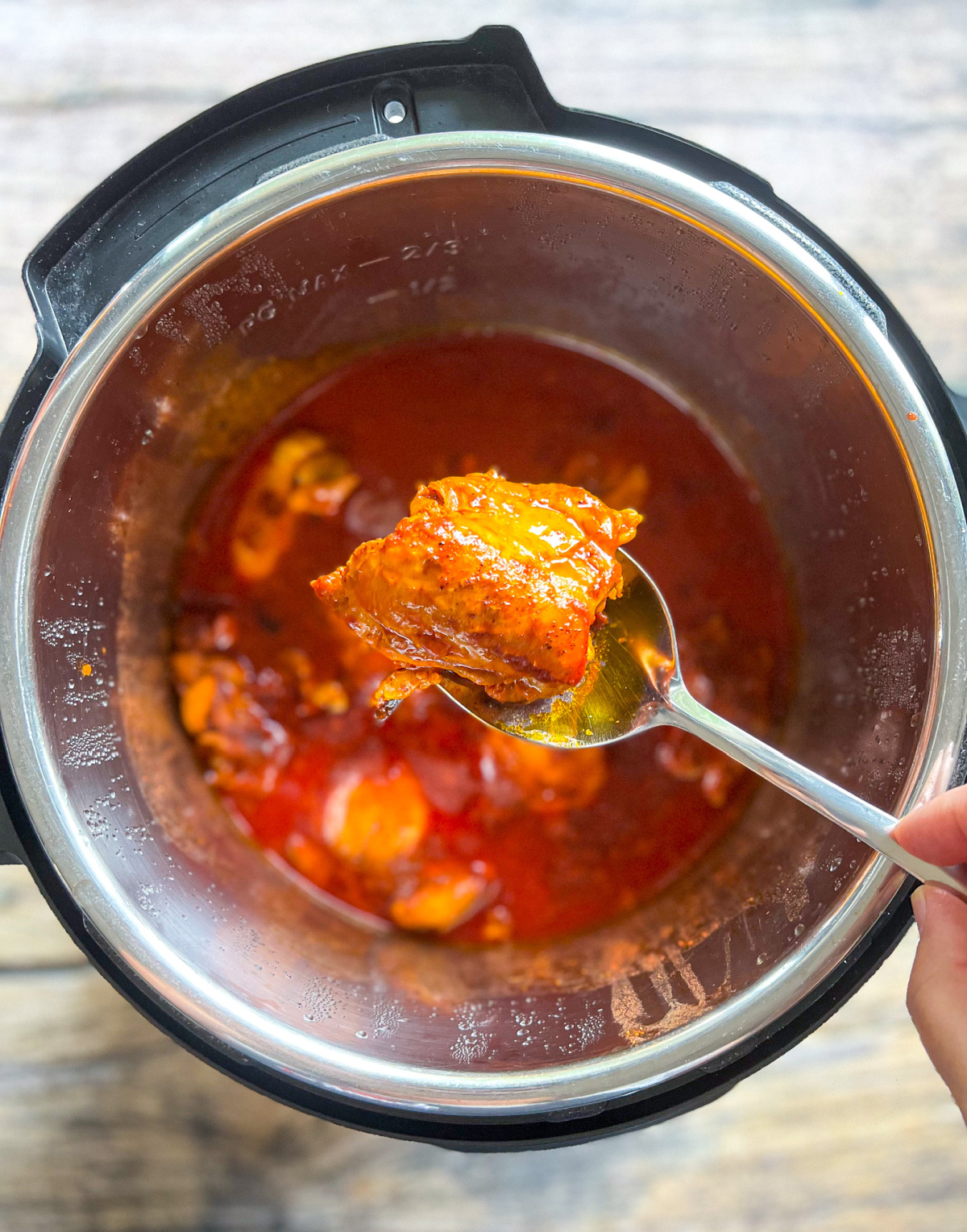 a spoon with cooked chicken