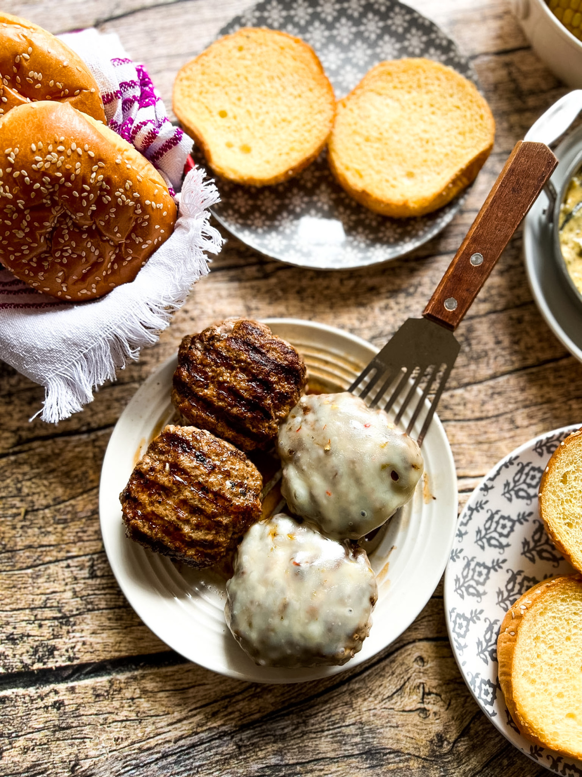 round plates with hamburgers and buns