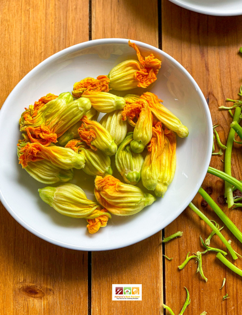 a plate with fresh squash blossoms or zucchini flowers