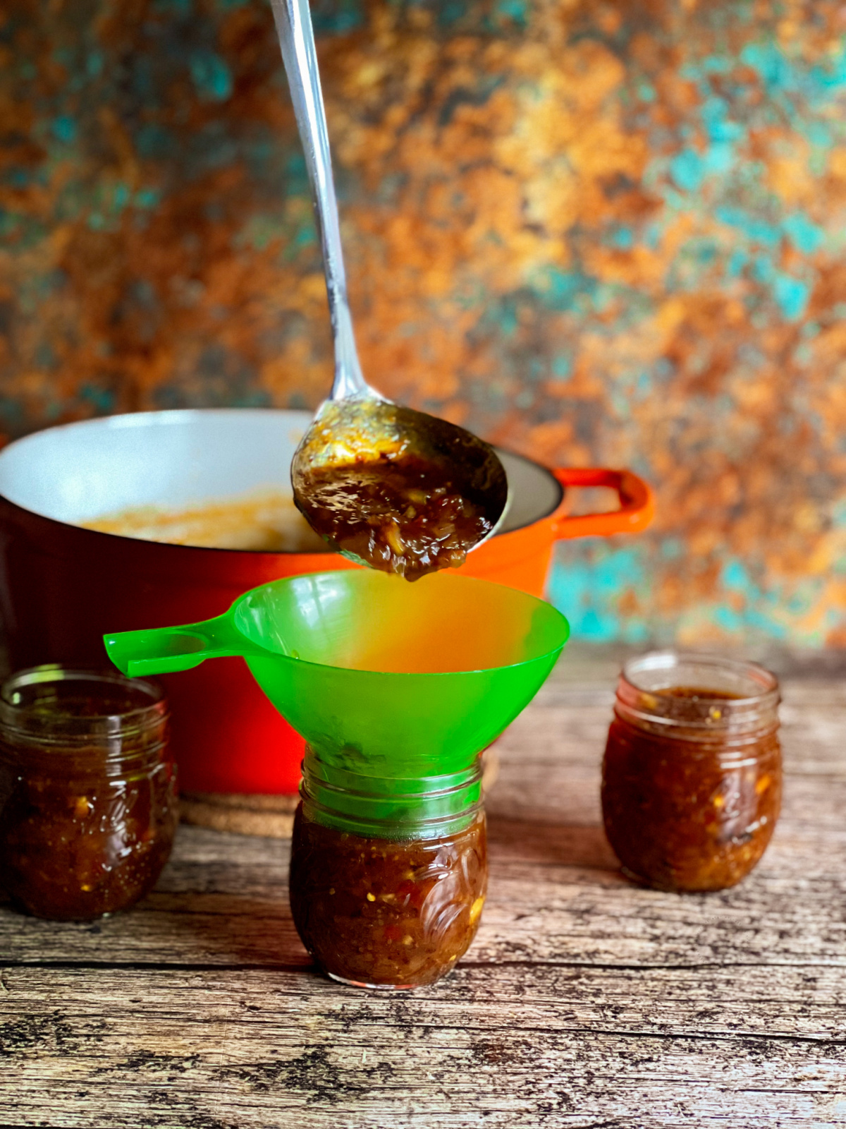 Ladling chutney into mason jars